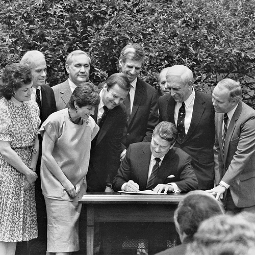 President Ronald Reagan signs the Minimum Legal Drinking Age-21 Law, alongside drunk driving victims and survivors from MADD, then-U.S. Transportation Secretary Elizabeth Dole, and Congressional sponsors