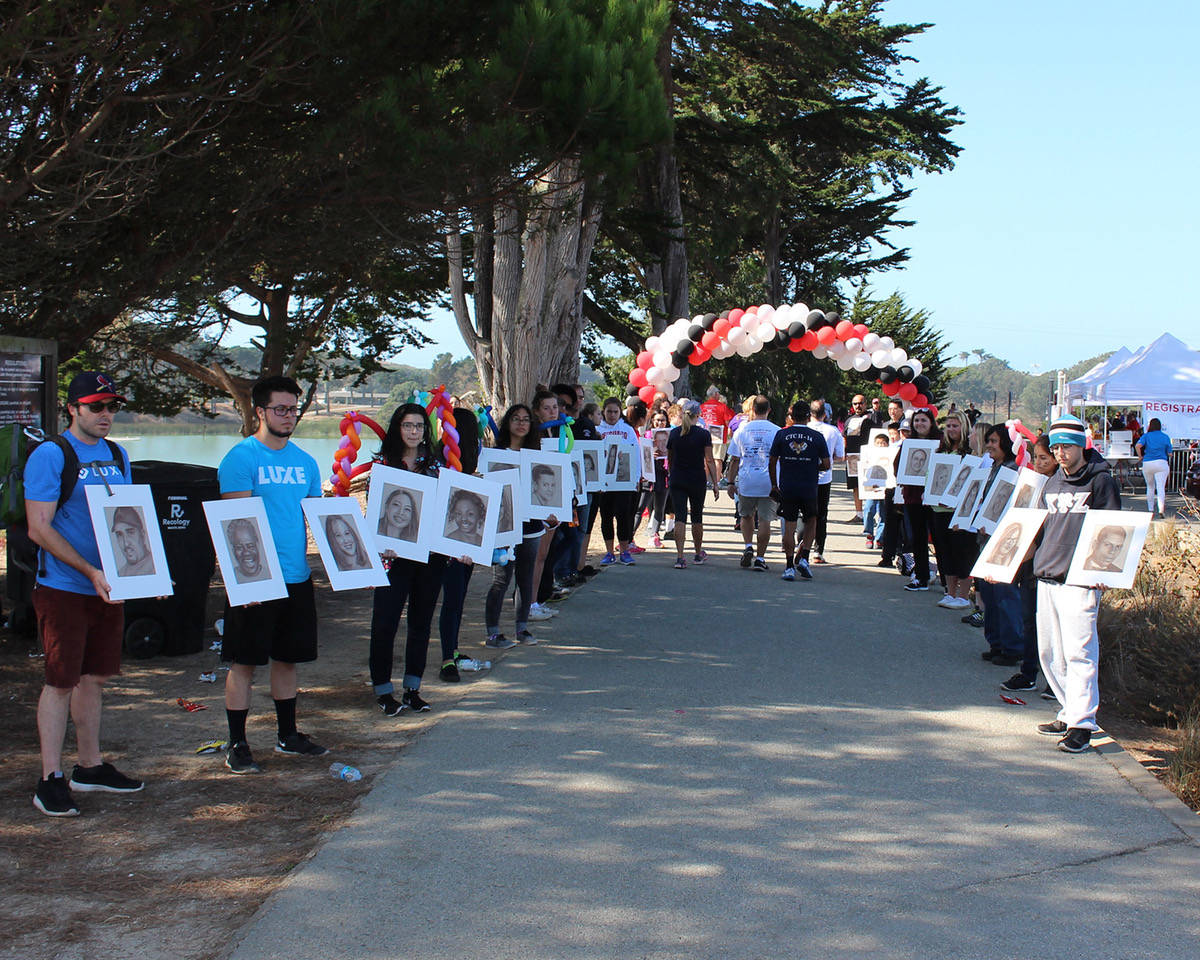 Loved ones line the walkway with portraits at the San Francisco Walk Like MADD Event.